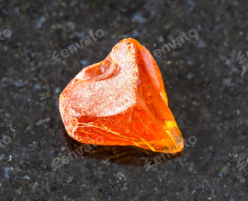 Preview: piece of Amber gemstone on black