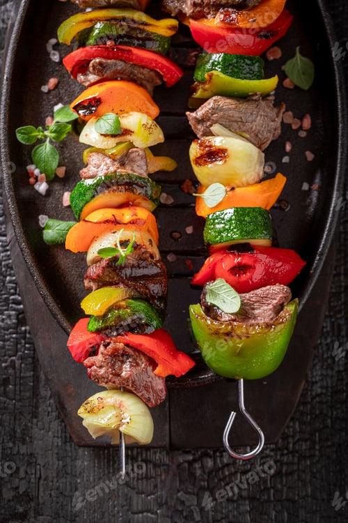 Preview: Tasty roasted skewer made on a metal grill.