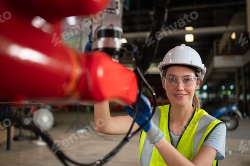 Preview: An engineers installing and testing a large robotic arm. before sending it to customers