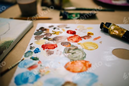 Preview: Multicolored palette in art studio, bright acrylic paints