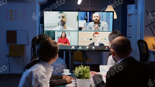 Preview: Multi ethnic businesspeople discussing company statistics with remote coworkers