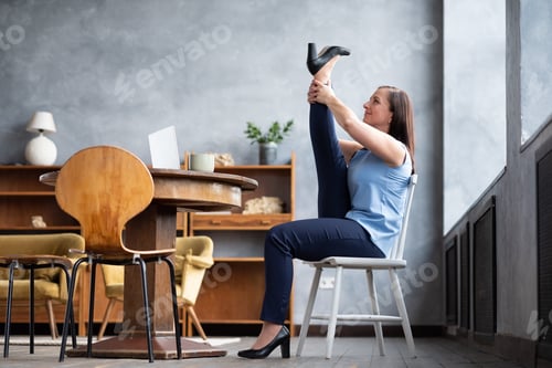 Preview: Woman practicing heron pose sitting at home relaxing during hard working day.