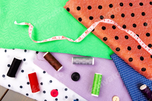 Preview: Items for sewing clothes. Sewing buttons, spools of thread and cloth. Top view.