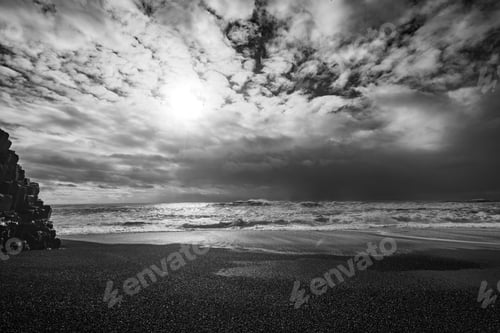 Preview: Mesmerizing peaceful view of a sandy beach and the wavy ocean in black and white