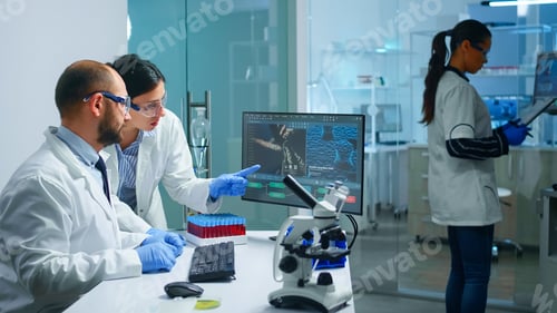 Preview: Chemist doctor explaining to coworker vaccine development