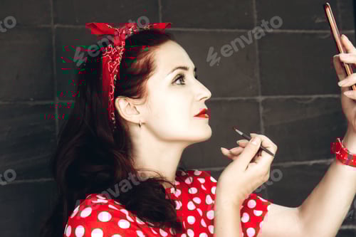 Preview: Young beautiful woman dressed in retro style