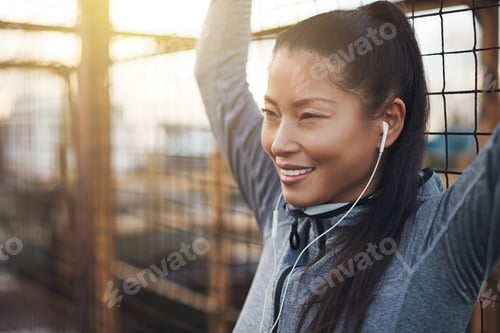 Preview: Fit young Asian woman standing outside before a run