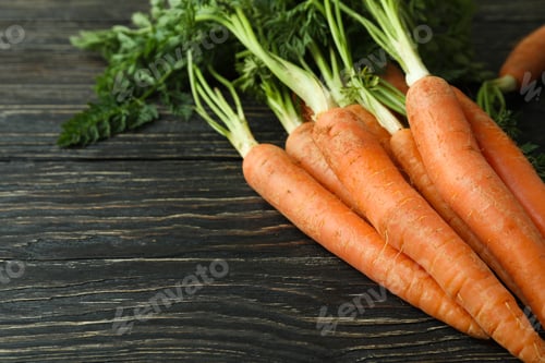 Preview: Heap of fresh carrot on wooden background