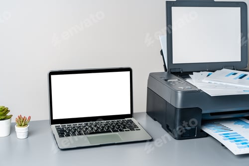 Preview: Printer and laptop on grey table in office