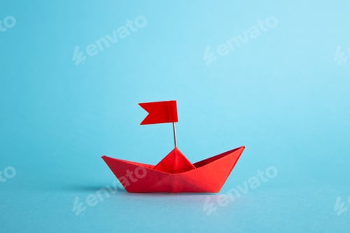 Preview: Red leader paper ship leading among others on blue background. Leadership concept.