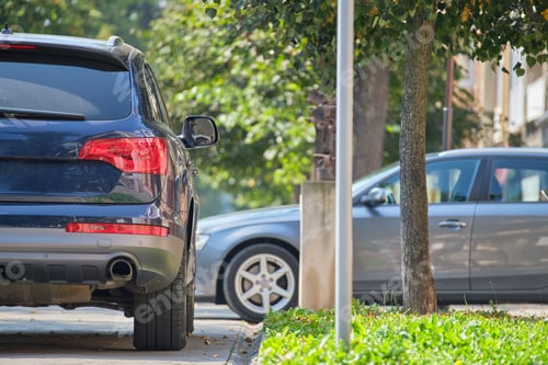 Preview: City traffic with cars parked in line on street side