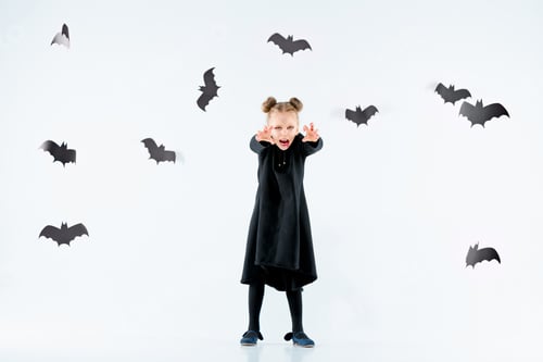 Preview: Little Girl Witch In Black Dress Over Magical Accessories. Halloween, The Studio Evening.