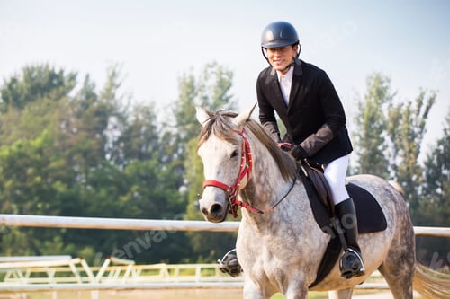 Preview: Cheerful young Chinese man riding horse