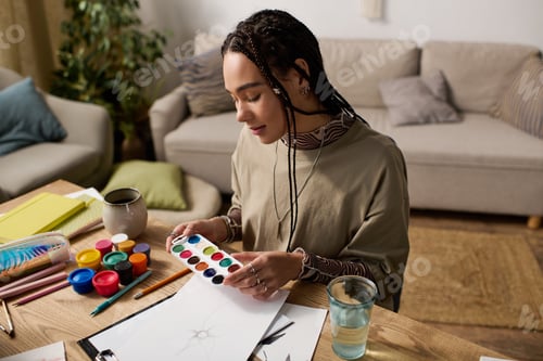 Preview: Creative bliss in a modern apartment with a young woman enjoying her art