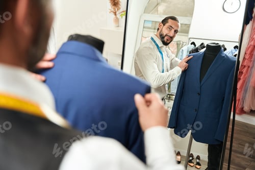 Preview: Tailor Inspecting a Jacket in His Shop