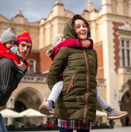 Preview: Happy family with two children on a walk in the old town of Europe