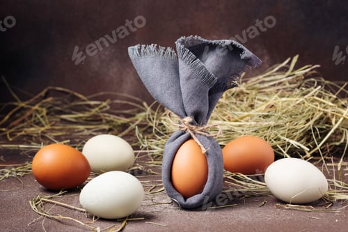 Preview: Easter egg decorated like a bunny on a brown concrete background