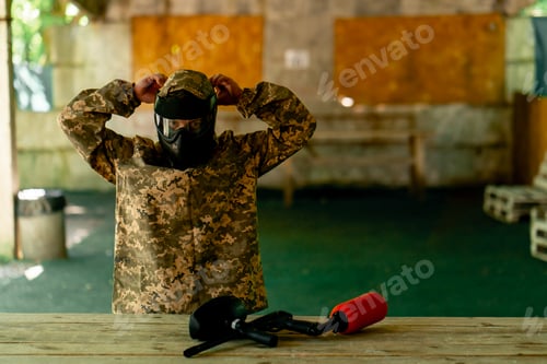 Preview: in the wild in the hangar for instructions a pintball coach puts on a uniform before the game full