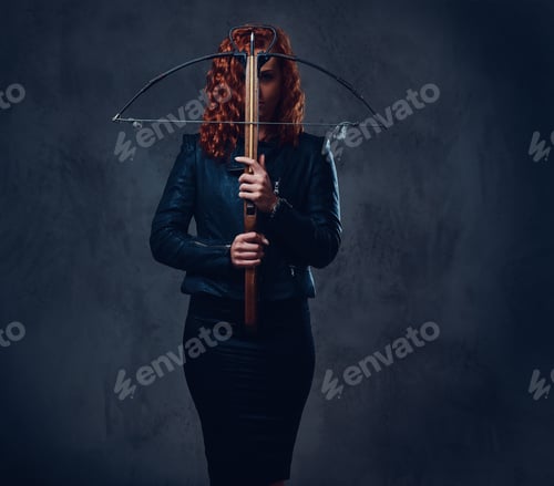 Preview: Redhead female holds crossbow.