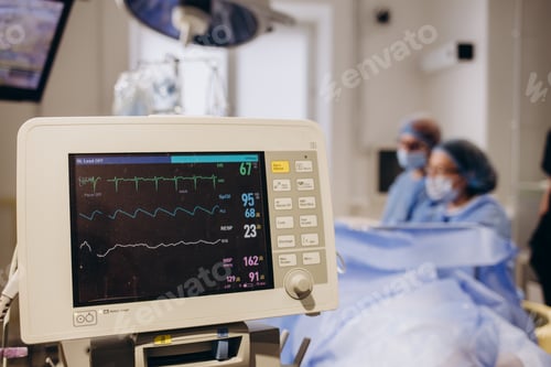 Preview: Medical researcher examining EKG image showing on monitor while patinet with mask running on cross