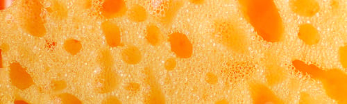 Preview: Banner of Yellow kitchen sponge background. Close up.