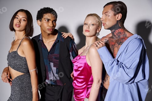 Preview: four stylish interracial friends posing together in evening attire on grey, New Year 2024 concept