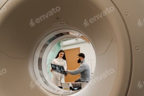Preview: CT doctor consulting male patient showing chest x-ray. Radiologist showing abdomen x-ray