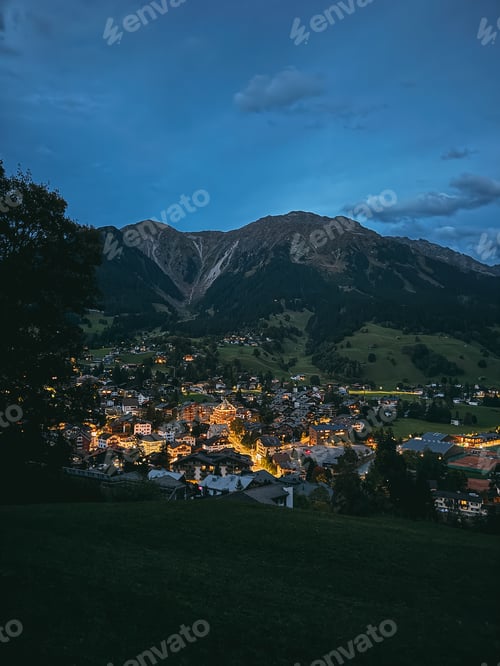 Preview: Alpine village town lights glowing at twilight