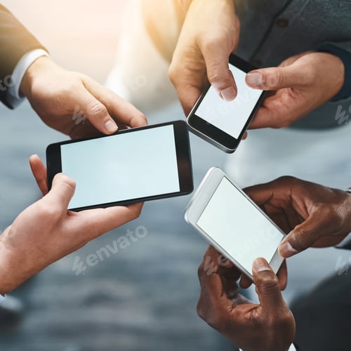 Preview: High angle shot of a group of unrecognizable businesspeople using their cellphones in the office