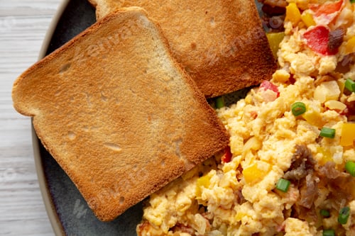 Preview: Homemade Fiesta Scrambled Eggs with Peppers and Toast on a Plate, top view.