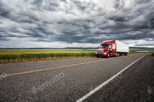 Preview: commercial truck driving though wheat fields of eastern Washington, USA at sunset.