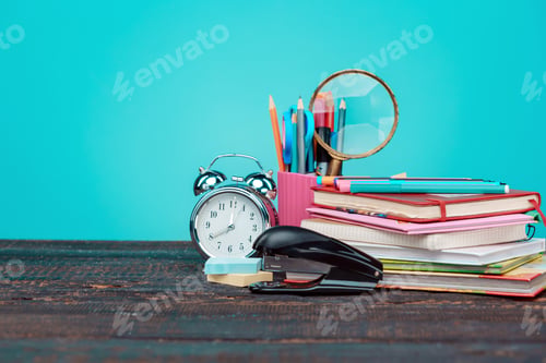 Preview: Back to School concept. Books, colored pencils and clock
