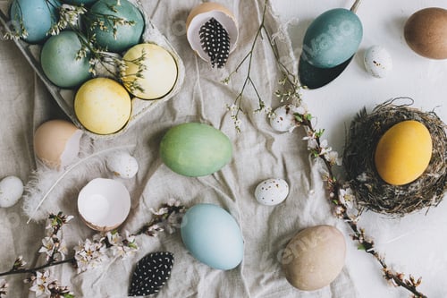 Preview: Stylish Easter eggs and cherry blossom on rustic linen background flat lay. Happy Easter