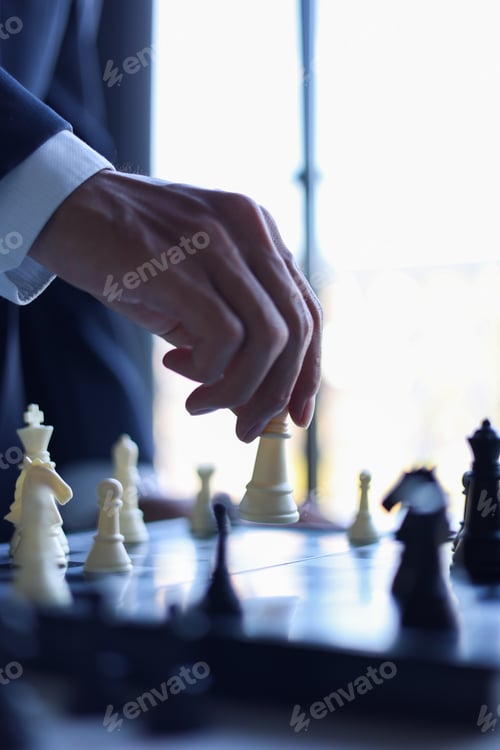 Preview: Businessman playing chess game; business strategy, leadership and management concept.