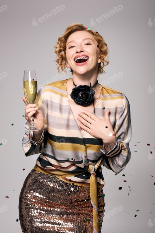 Preview: A cheerful woman celebrates with laughter, holding a drink surrounded by festive decorations