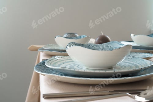 Preview: Details of a stylish table setting with textured ceramic dishes