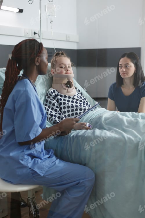 Preview: Pediatric hospital nurse checking young patient record file and injury history