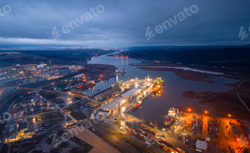 Preview: View of a heavily smoking factory at night, industrial area aerial view