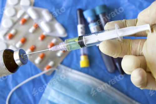Preview: Hand in glove holding syringe and vial with drugs, test tubes, and mask background