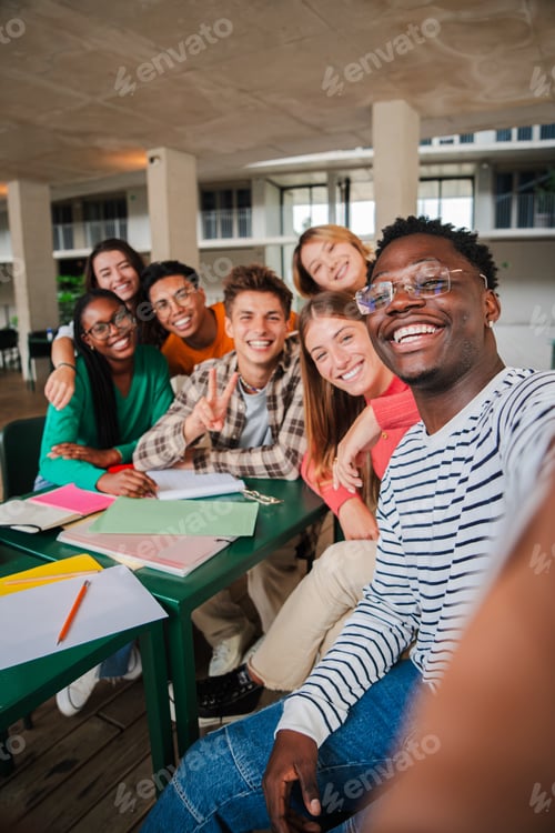 Preview: Happy young students taking a vertical selfie portrait together at university library. African
