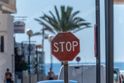 Preview: Selective focus shot of red hexagonal stop street sign on the harbor in Majorca, Spain