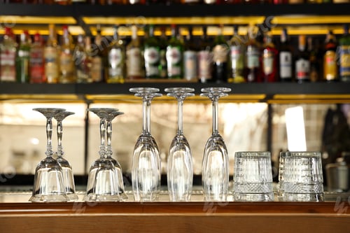 Preview: Different empty clean glasses on counter in bar