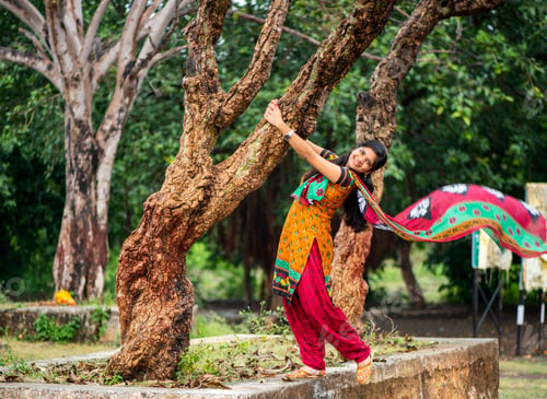 Preview: Young girl near tree trunk and she enjoying fresh air outdoors