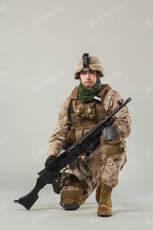 Preview: Military soldier poses in uniform with rifle in a studio setting
