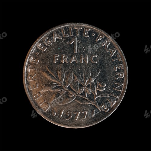 Preview: Closeup of a 1 franc coin from 1977 on a black background, the former French national currency