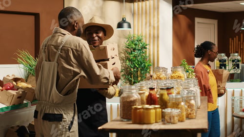 Preview: African american supplier giving fresh produce in crates to merchant