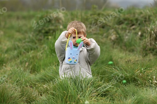 Preview: A boy looking for eggs in a bag for Easter