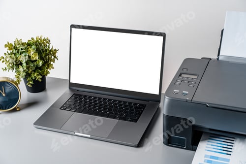 Preview: Printer and laptop on grey table in office