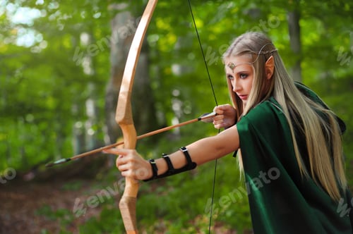 Preview: Beautiful female elf archer in the forest hunting with a bow