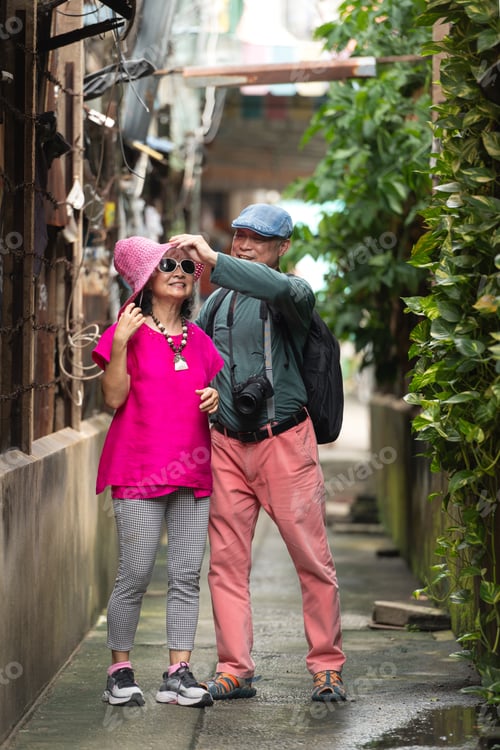 Preview: A happy senior couple strolling along a city's old neighborhood, enjoying travel
